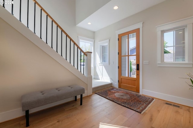 entrance foyer with plenty of natural light and hardwood / wood-style flooring