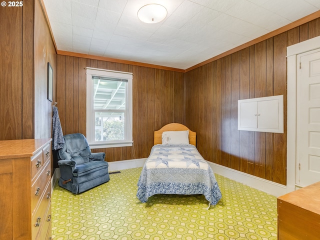 bedroom with crown molding and wood walls