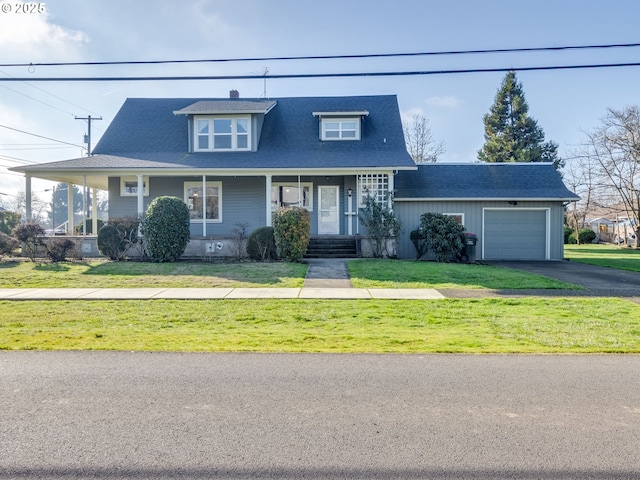 view of front of house featuring a garage, a front lawn, and a porch