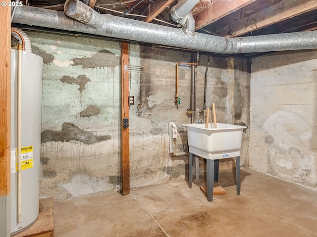 basement featuring water heater and sink