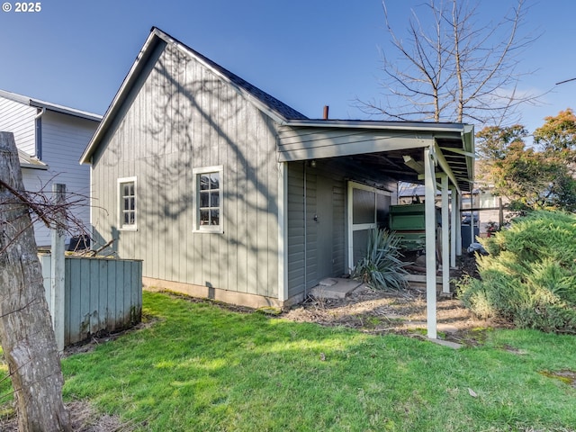 rear view of property with a lawn