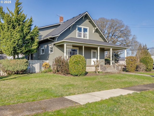 view of front of house featuring covered porch and a front lawn