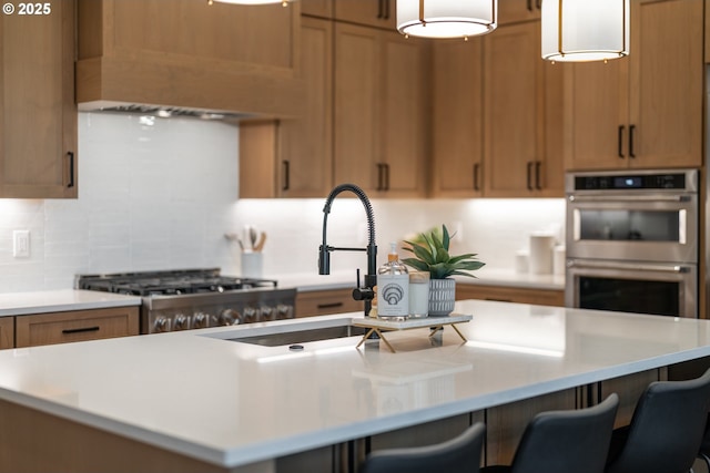 1669 NW Goodwin St, Camas, WA 98607 - kitchen featuring double oven, light countertops, brown cabinets, and a kitchen island with sink