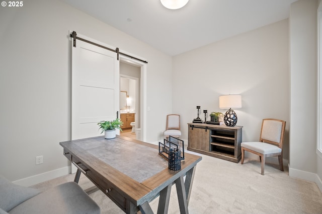 1669 NW Goodwin St, Camas, WA 98607 - home office featuring a barn door, baseboards, and light carpet