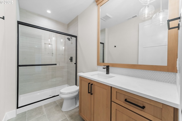 1669 NW Goodwin St, Camas, WA 98607 - bathroom with a stall shower, toilet, vanity, backsplash, and tile patterned floors