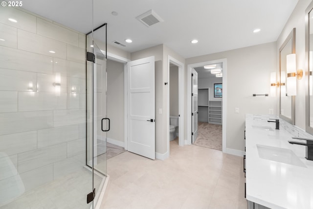 1669 NW Goodwin St, Camas, WA 98607 - full bath with a stall shower, toilet, baseboards, double vanity, and tile patterned floors