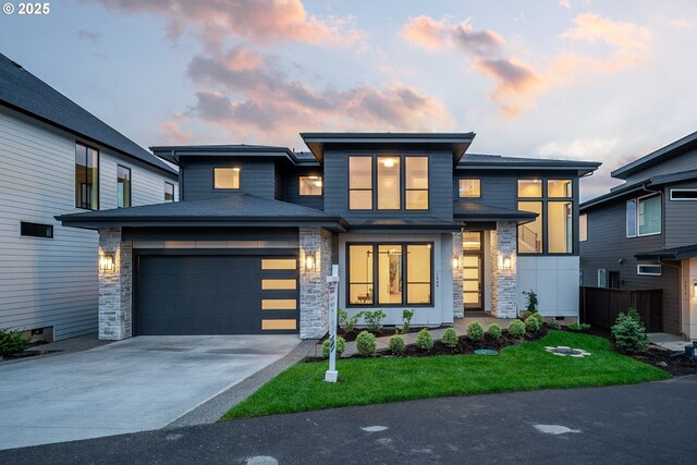 1669 NW Goodwin St, Camas, WA 98607 - contemporary house featuring an attached garage, driveway, and stone siding