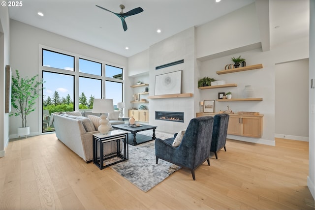 1669 NW Goodwin St, Camas, WA 98607 - living room with ceiling fan, a fireplace, light wood-style flooring, built in features, and recessed lighting