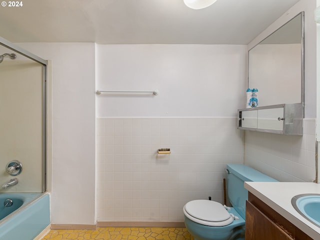 full bathroom with vanity, shower / tub combination, tile patterned floors, tile walls, and toilet