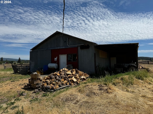 view of outdoor structure with an outbuilding and fence