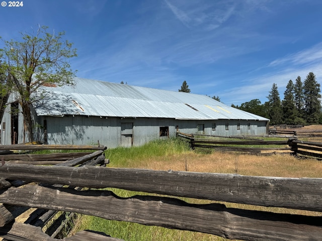 view of side of property featuring metal roof and an outbuilding