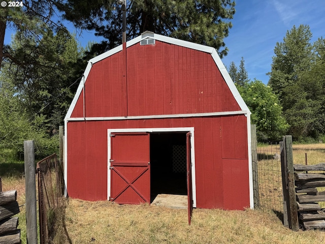 view of outdoor structure with an outbuilding and fence