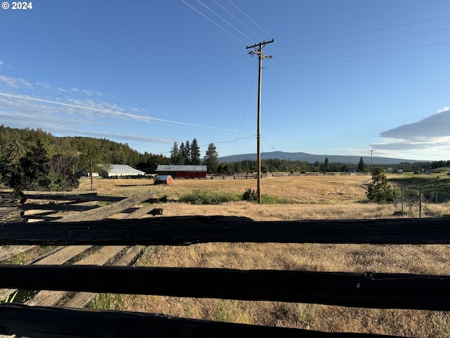 view of yard featuring a mountain view and a rural view