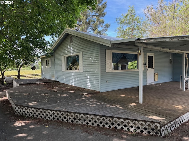 view of side of property featuring a wooden deck