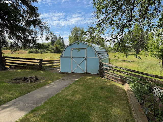 view of shed featuring fence and a rural view