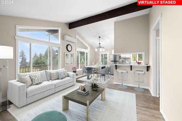 living room featuring a wall mounted air conditioner, light hardwood / wood-style flooring, vaulted ceiling with beams, and a chandelier