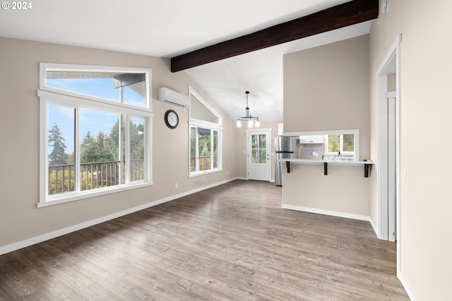 unfurnished living room featuring dark hardwood / wood-style flooring, vaulted ceiling with beams, a notable chandelier, and a wall unit AC