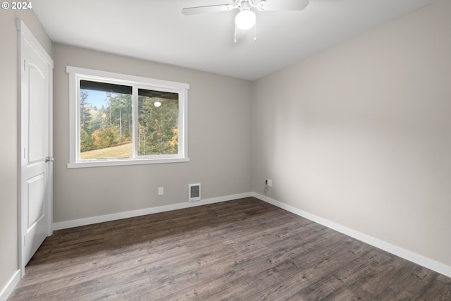 spare room with ceiling fan and dark hardwood / wood-style flooring