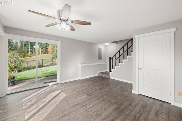 unfurnished living room with dark hardwood / wood-style flooring and ceiling fan