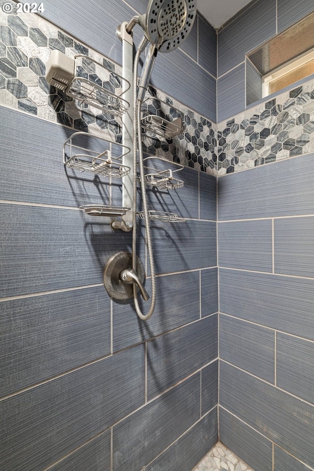 bathroom with a tile shower