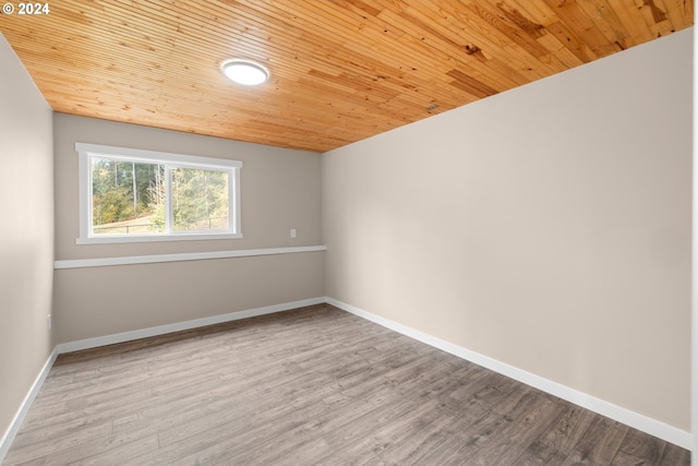 spare room with wood ceiling and light hardwood / wood-style flooring