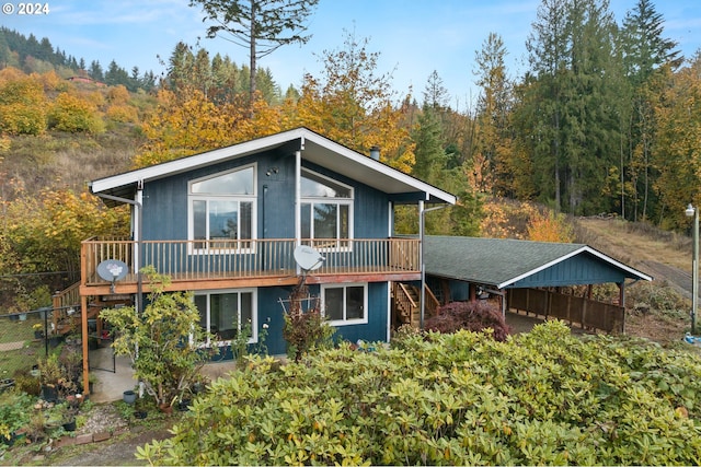 rear view of house featuring a deck