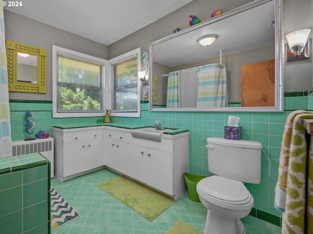 bathroom with vanity, a shower with shower curtain, toilet, tile walls, and radiator heating unit