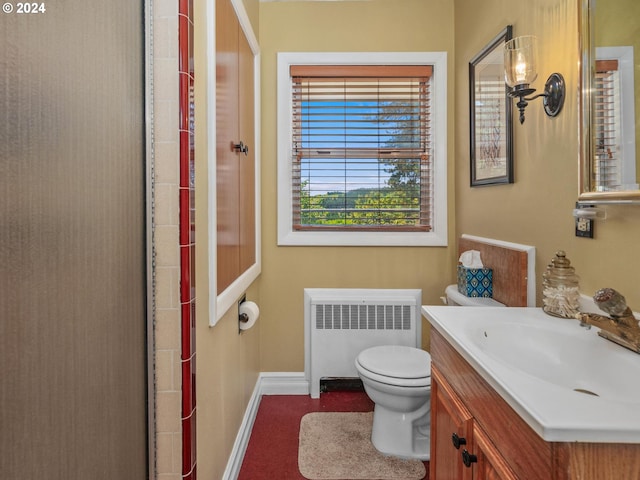 bathroom featuring radiator heating unit, vanity, and toilet