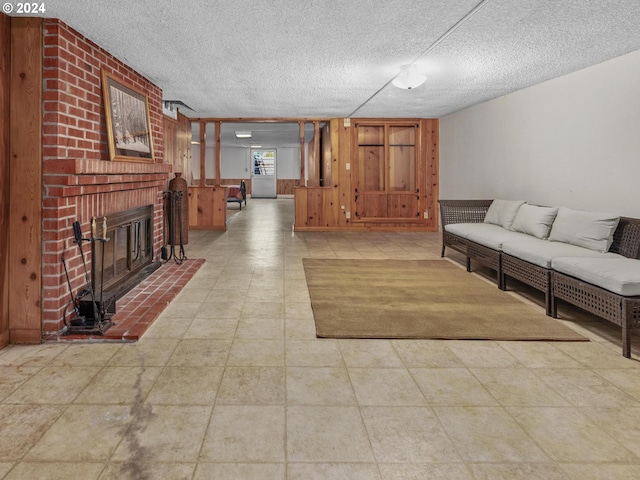 unfurnished living room featuring wooden walls, a fireplace, and a textured ceiling