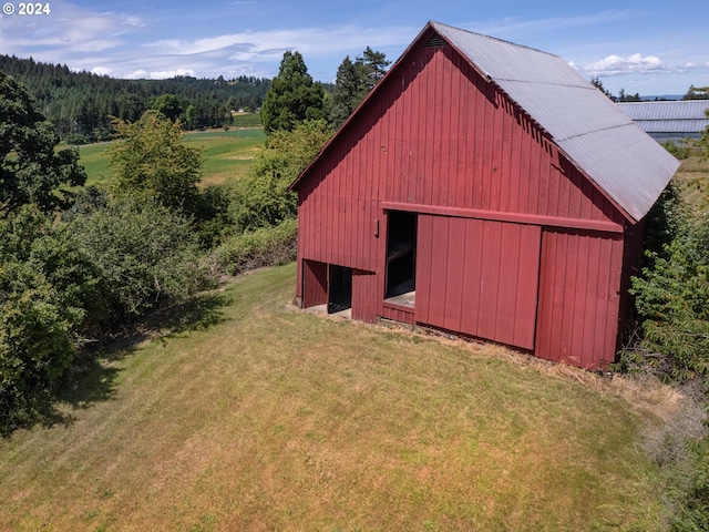 view of outbuilding featuring a lawn