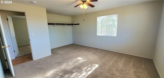 unfurnished bedroom with a closet, carpet flooring, and ceiling fan