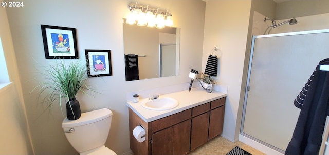 bathroom with vanity, an enclosed shower, and toilet