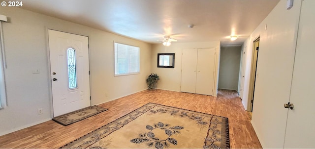 foyer entrance with light hardwood / wood-style floors and ceiling fan