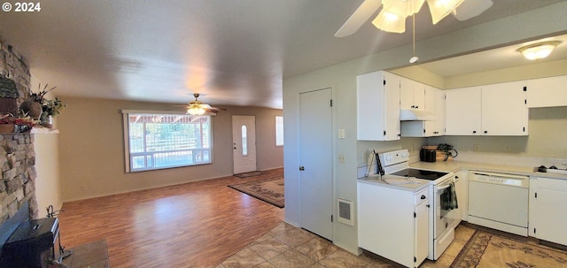 kitchen with light hardwood / wood-style flooring, ceiling fan, white appliances, and white cabinets