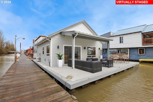 back of house featuring outdoor lounge area