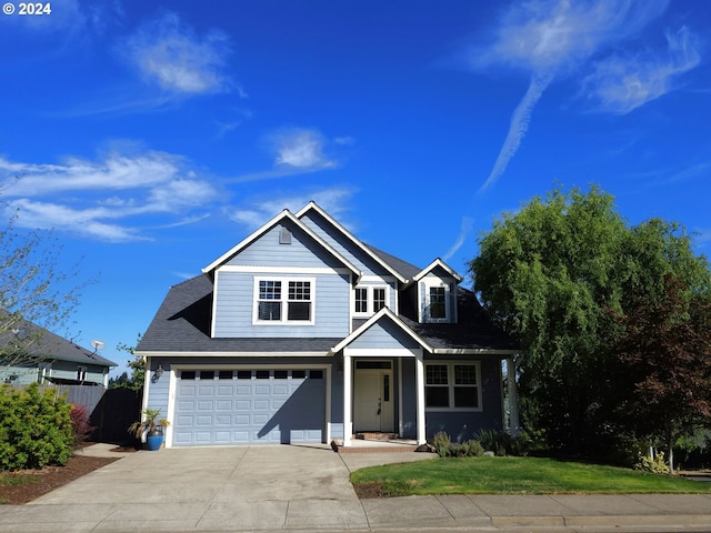 view of front of home with a garage and a front yard