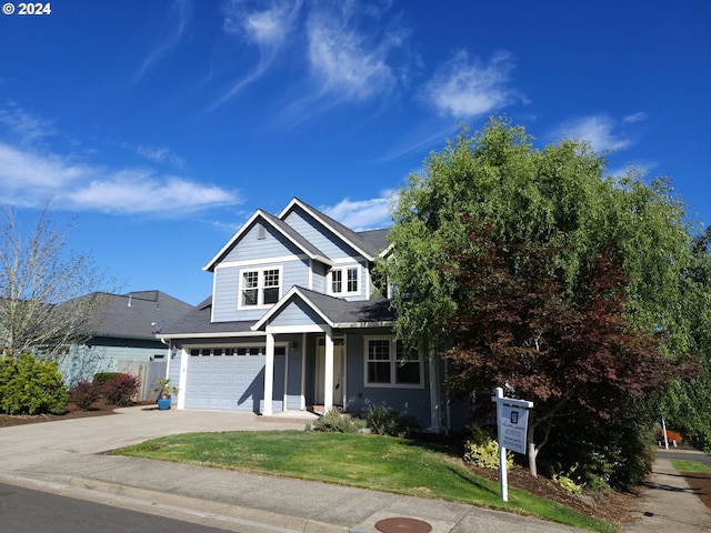 view of front of house with a garage and a front lawn