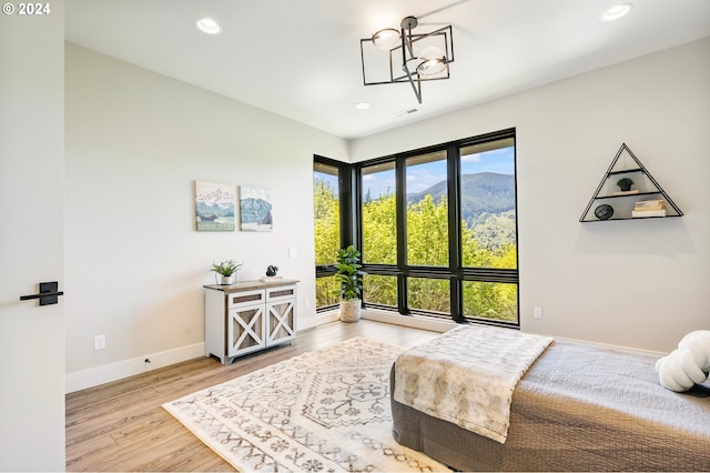 bedroom with an inviting chandelier and wood-type flooring