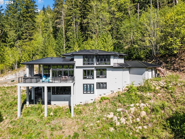 back of property with a sunroom