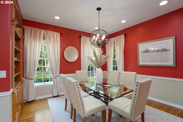 dining space with an inviting chandelier and light wood-type flooring