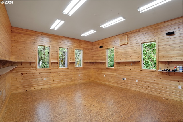 spare room featuring wooden walls