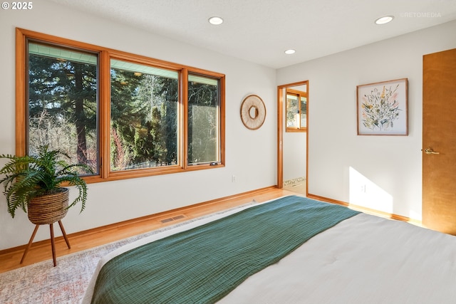 bedroom with hardwood / wood-style floors