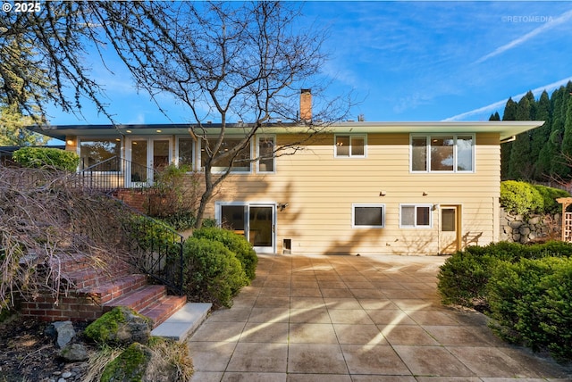 back of house with a patio