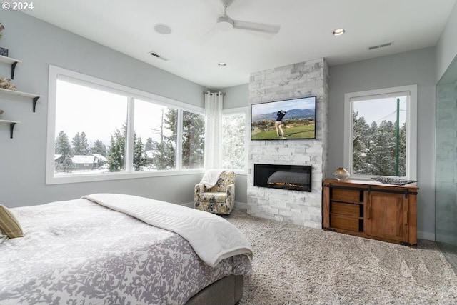 3425 NW Fairway Heights Dr, Bend, OR 97703 - bedroom featuring a stone fireplace, a ceiling fan, and recessed lighting