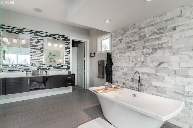 3425 NW Fairway Heights Dr, Bend, OR 97703 - bathroom featuring a freestanding tub, tile walls, vanity, and recessed lighting