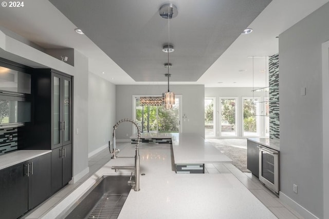 3425 NW Fairway Heights Dr, Bend, OR 97703 - workout area featuring wine cooler, baseboards, a chandelier, recessed lighting, and a sink