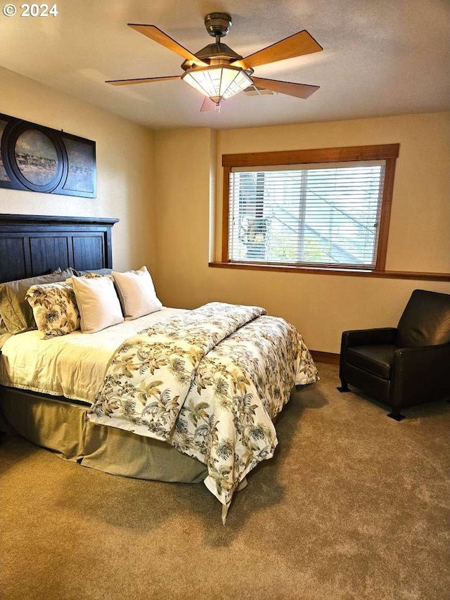 carpeted bedroom featuring ceiling fan