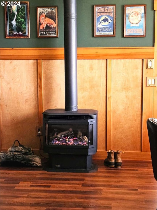 interior details featuring a wood stove and hardwood / wood-style floors