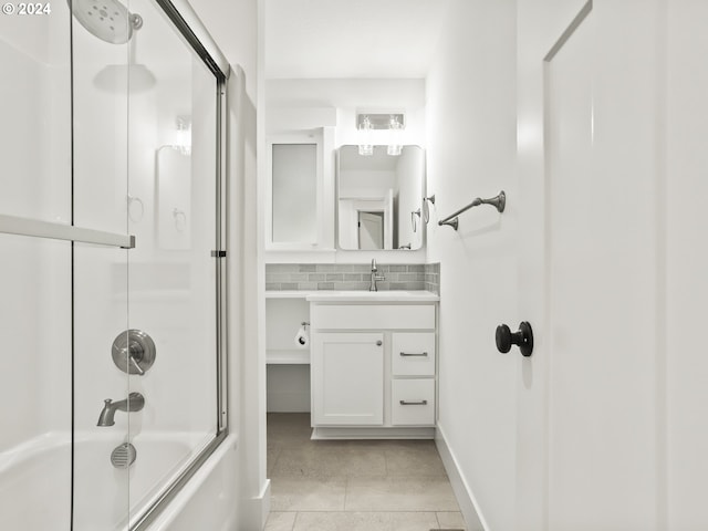 bathroom with bath / shower combo with glass door, vanity, tile patterned floors, and decorative backsplash