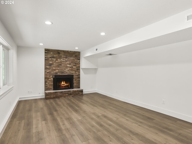 unfurnished living room with hardwood / wood-style floors and a fireplace